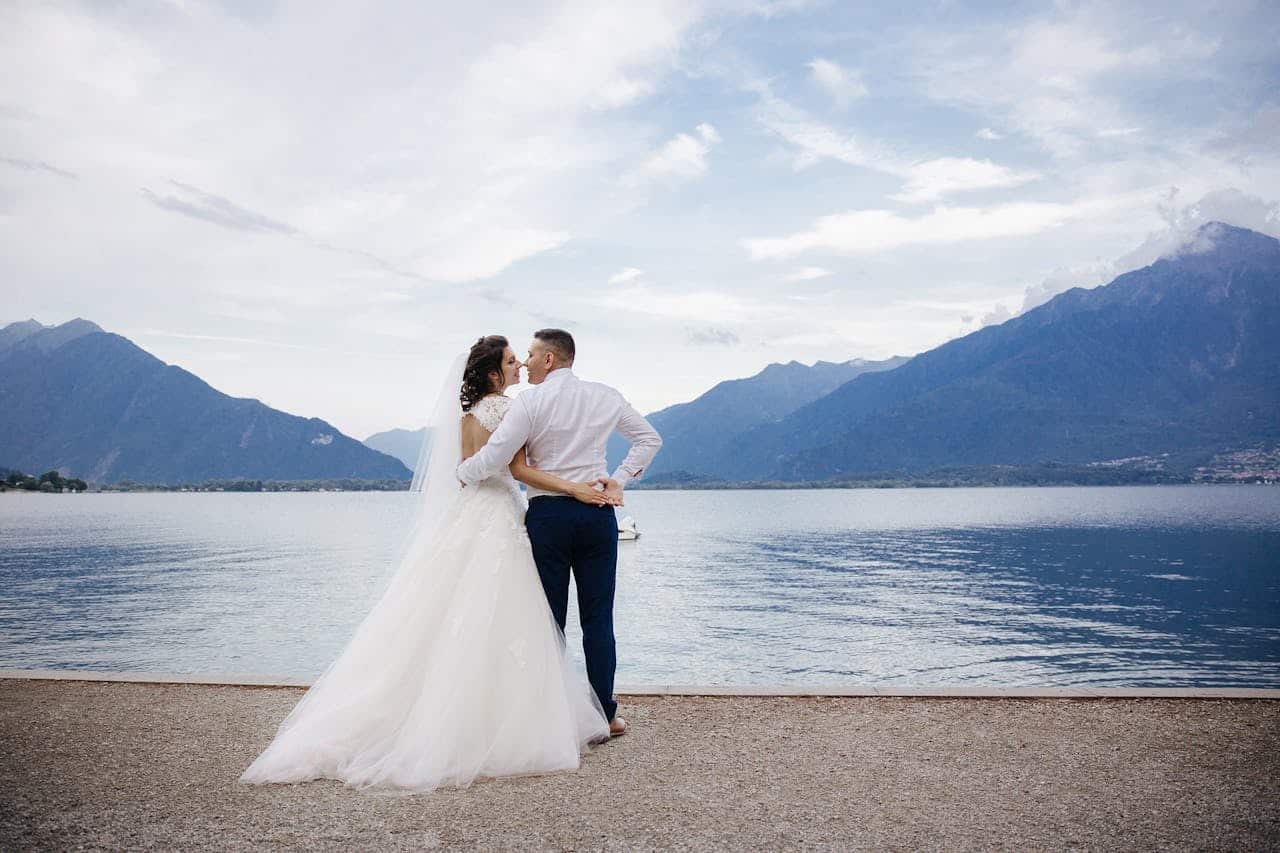 heros-img Bride and groom share a romantic moment by Lake Como in Menaggio, Italy.